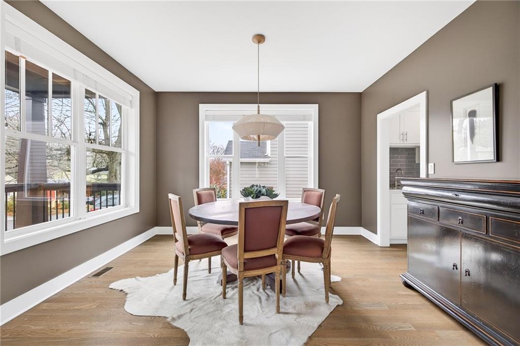 209 Ridgeland Avenue Decatur, GA 30030 - Photo 12 of 23 a dining room with furniture a chandelier and wooden floor