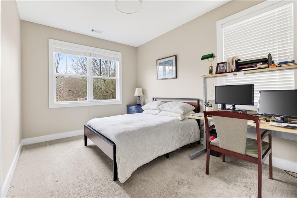 209 Ridgeland Avenue Decatur, GA 30030 - Photo 19 of 23 a bedroom with a bed and a desk