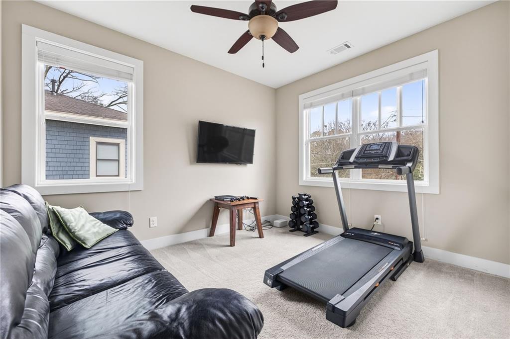 209 Ridgeland Avenue Decatur, GA 30030 - Photo 20 of 23 a living room with furniture and a flat screen tv