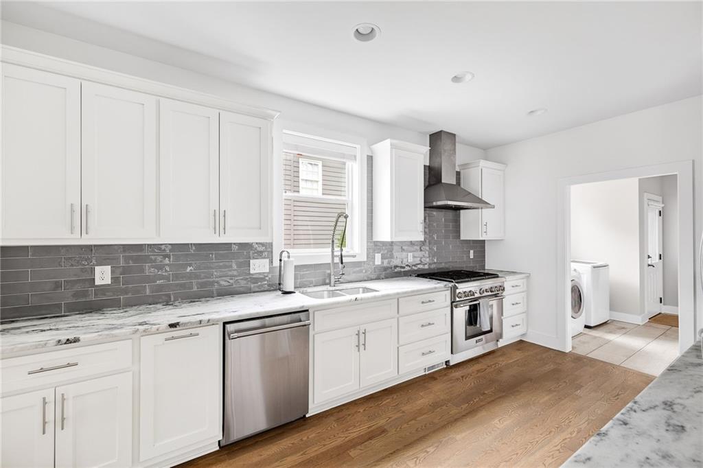 209 Ridgeland Avenue Decatur, GA 30030 - Photo 6 of 23 a kitchen with a sink stove and cabinets
