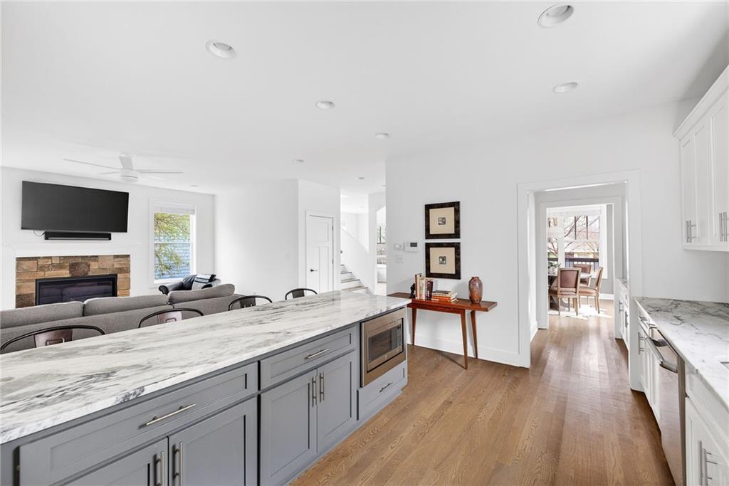 209 Ridgeland Avenue Decatur, GA 30030 - Photo 7 of 23 a spacious bathroom with a granite countertop sink and a large mirror