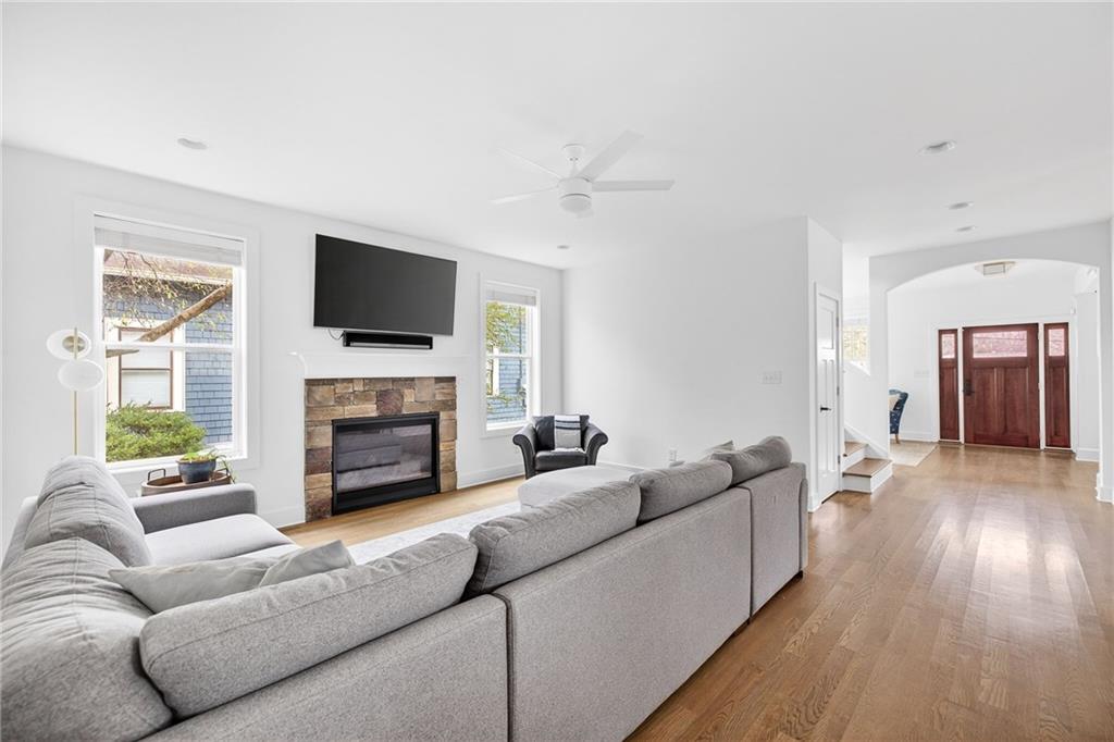 209 Ridgeland Avenue Decatur, GA 30030 - Photo 8 of 23 a living room with furniture a fireplace and a flat screen tv