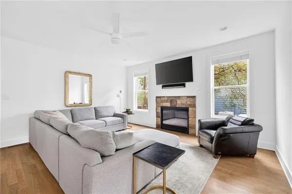 a living room with furniture a fireplace and a flat screen tv