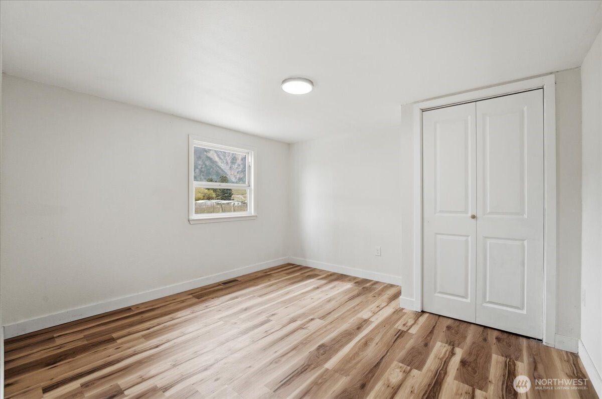 293 Barkley Road Manson, WA 98831 - Photo 18 of 40 a view of empty room with wooden floor