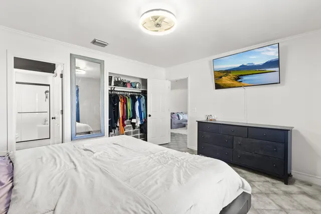 a bedroom with a bed and a dresser