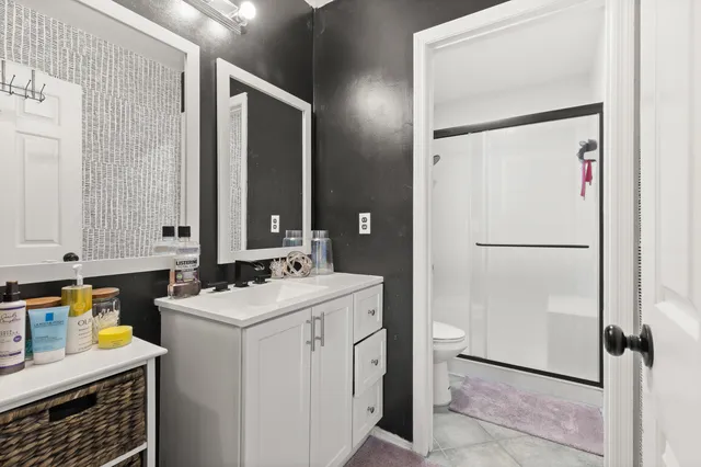 a room with a sink and a refrigerator