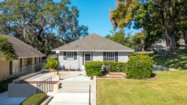 a front view of a house with a garden