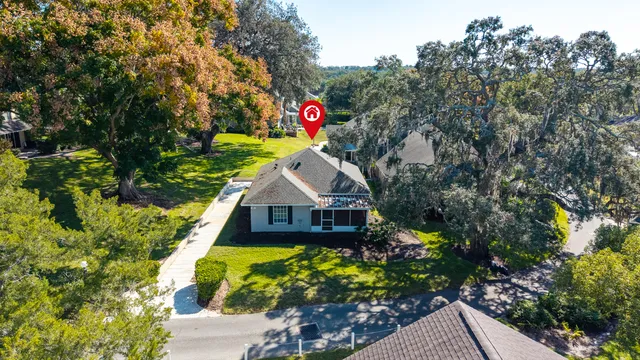 a view of a house with a yard and potted plants