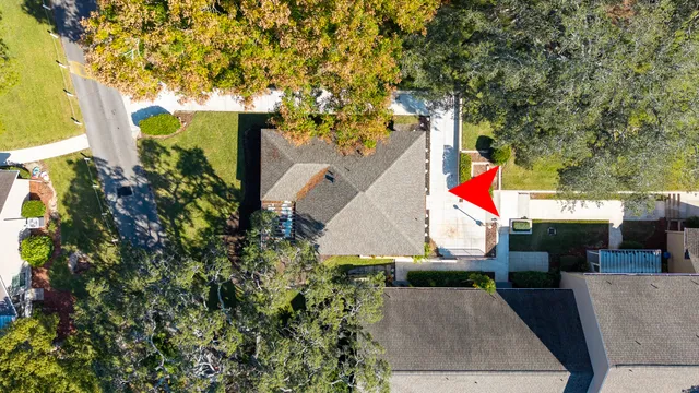 an aerial view of a house with large trees