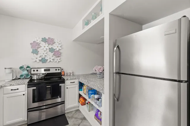 a kitchen with a refrigerator and a stove