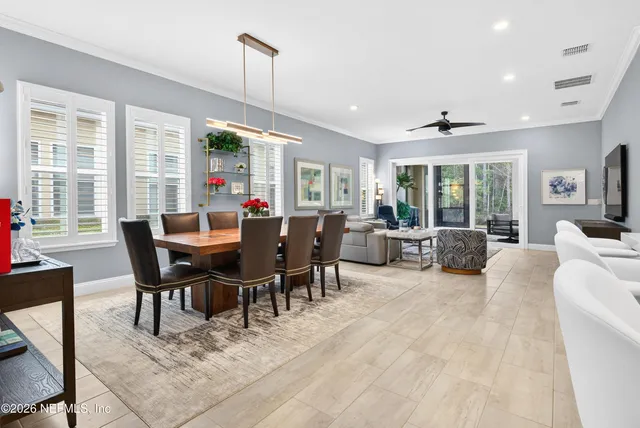 a living room with furniture and kitchen view