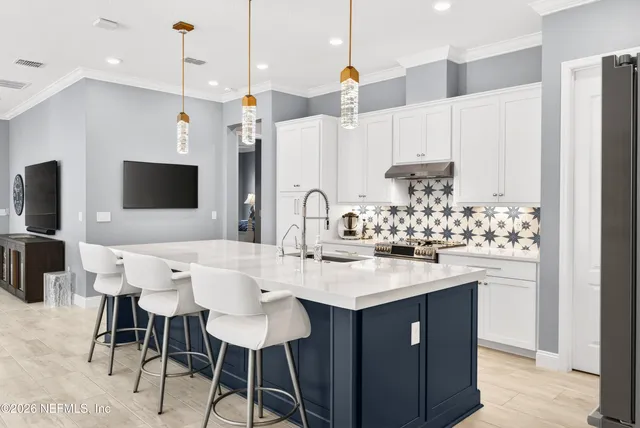 a spacious bathroom with a sink a toilet and a mirror