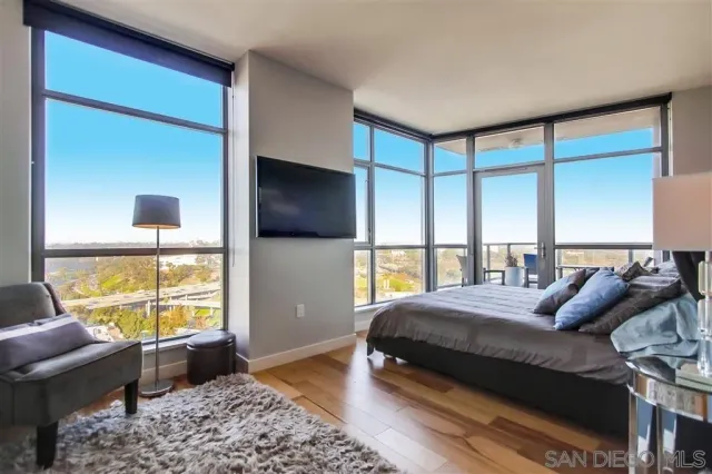 a bedroom with a bed and large window