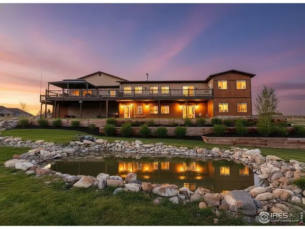 a aerial view of a house with a garden and lake view