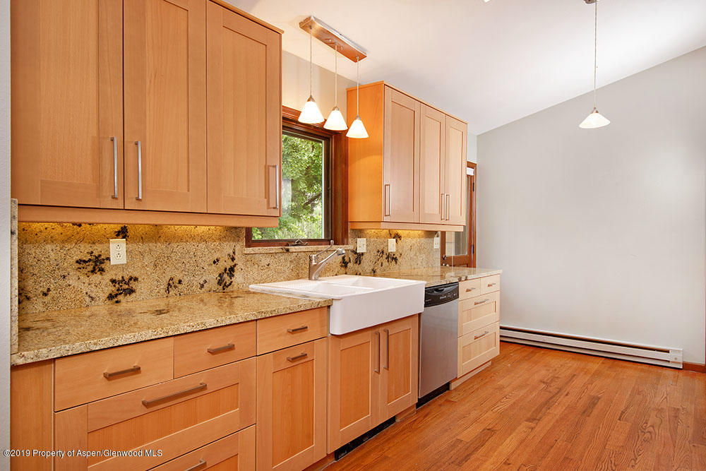 113 Crossland Drive Basalt, CO 81621 - Photo 3 of 23 a view of a kitchen with a sink and dishwasher with wooden floor