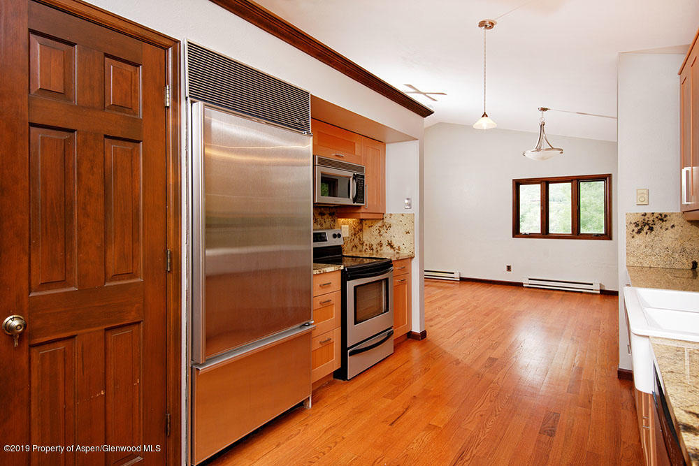 113 Crossland Drive Basalt, CO 81621 - Photo 4 of 23 a kitchen with a refrigerator and a stove top oven
