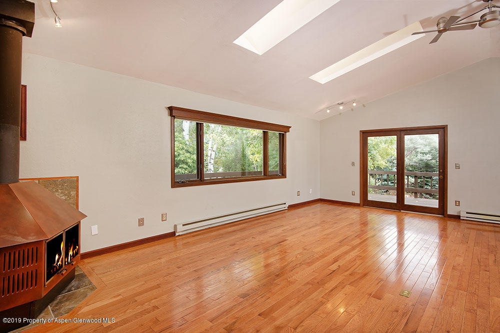 113 Crossland Drive Basalt, CO 81621 - Photo 6 of 23 an empty room with wooden floor and windows
