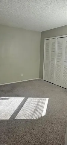 a kitchen with cabinets and white stainless steel appliances