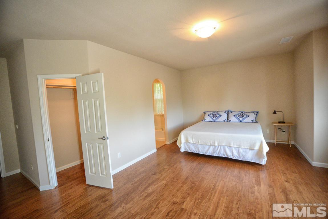 1897 Resistol Drive Reno, NV 89521 - Photo 6 of 9 a bedroom with a bed and wooden floor