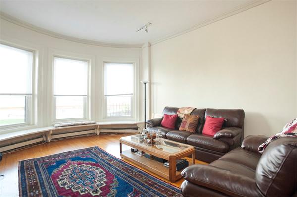 7 Bay State Road, Unit 2C Boston, MA 02215 - Photo 2 of 7 a living room with furniture and a rug