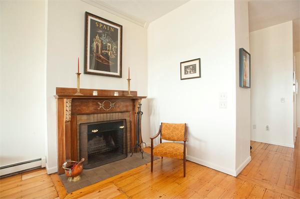 7 Bay State Road, Unit 2C Boston, MA 02215 - Photo 3 of 7 a living room with furniture and a fireplace