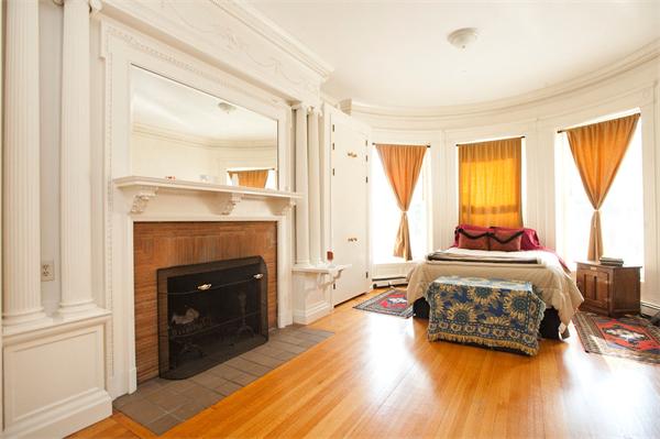 7 Bay State Road, Unit 2C Boston, MA 02215 - Photo 5 of 7 a bedroom with a bed and a fireplace