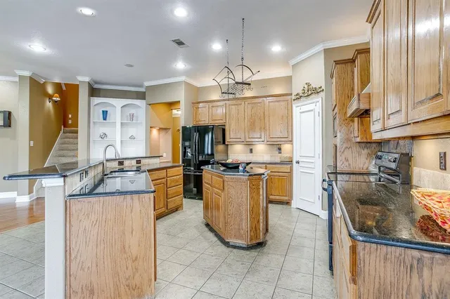 a kitchen with counter top space appliances and cabinets