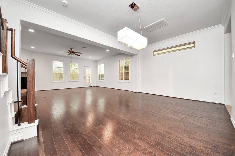 4222 Drake Street Houston, TX 77005 - Photo 5 of 28 a view of an empty room with wooden floor and a window