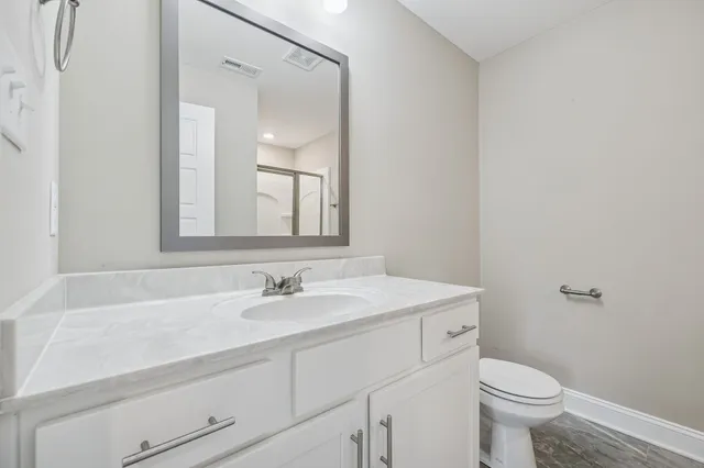 a bathroom with a sink toilet and a mirror