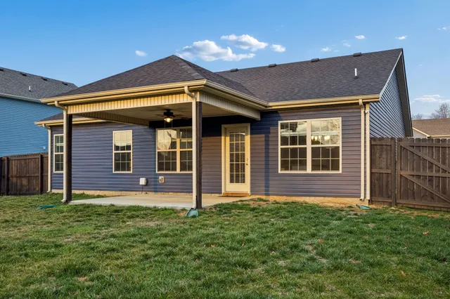 a view of house with backyard