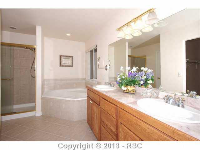 15028 Herring Road Colorado Springs, CO 80908 - Photo 7 of 17 Private, adjoining master bath with soaking tub and dual sinks