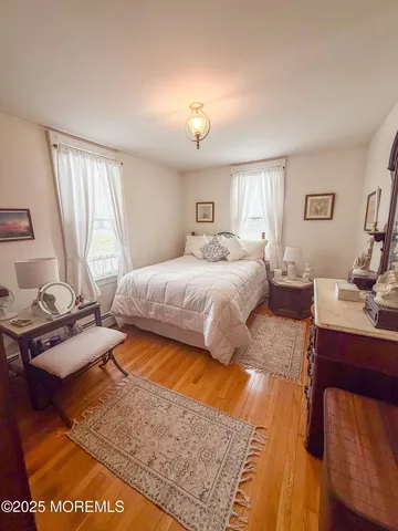 a bedroom with a bed and a night stand