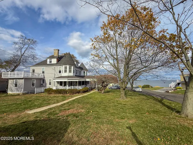a view of a white house with a large pool