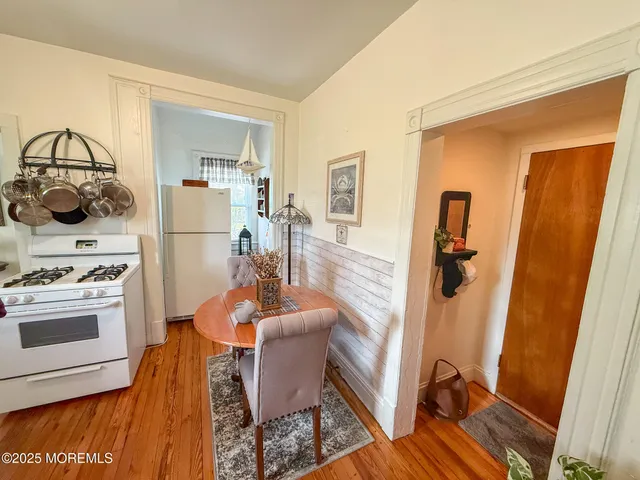 a living room with furniture a rug and kitchen view