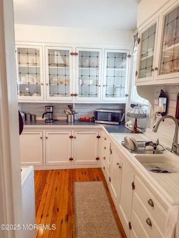 a kitchen with stainless steel appliances cabinets a stove and a window