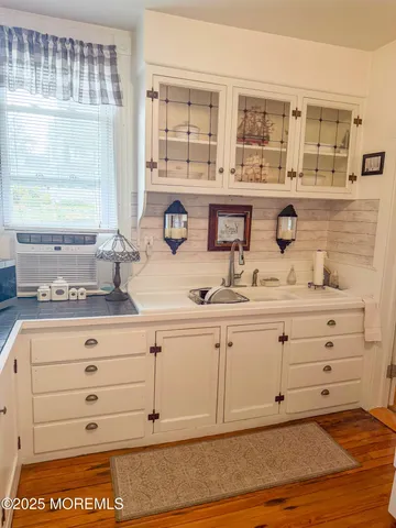 a bathroom with sink mirror and window