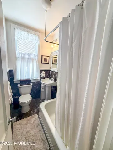 a living room with furniture a fireplace and a window