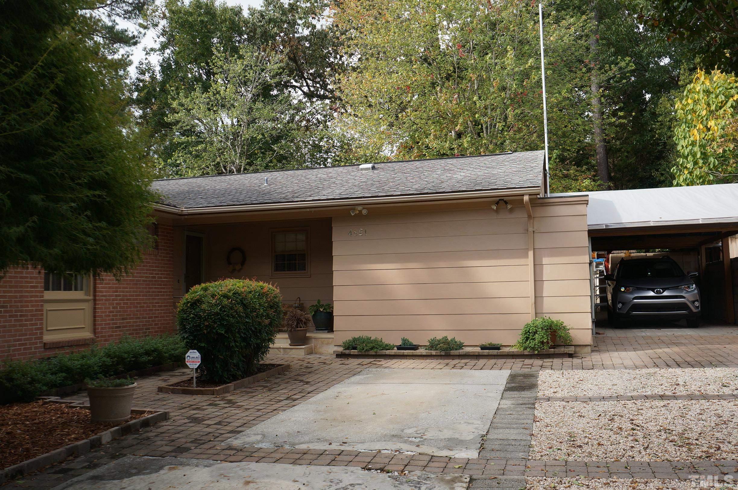 4821 Latimer Road Raleigh, NC 27609 - Photo 2 of 21 a front view of a house with a yard and garage