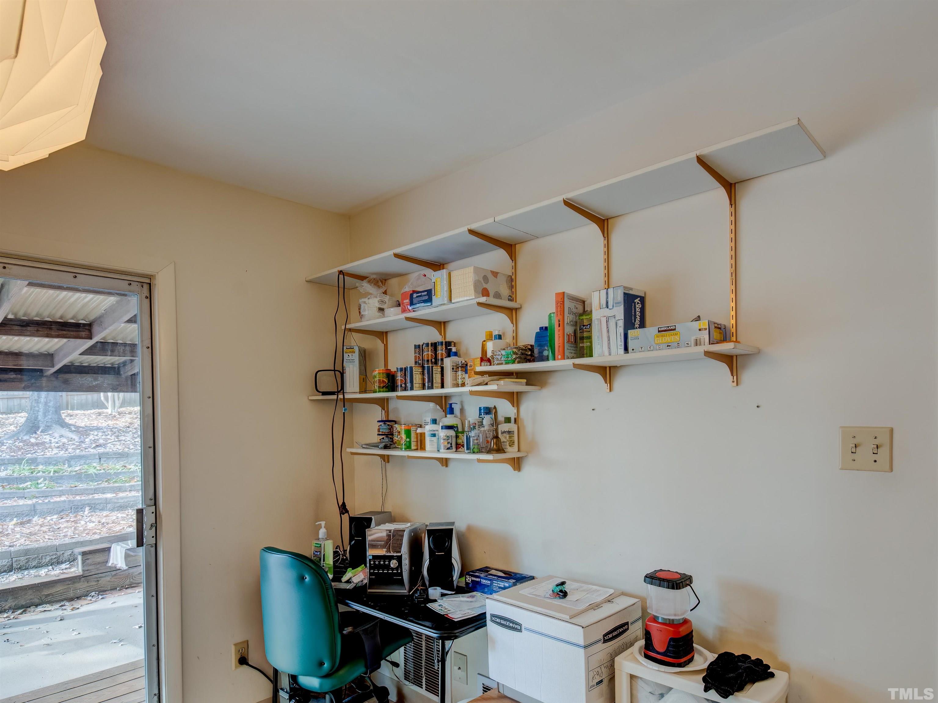 4821 Latimer Road Raleigh, NC 27609 - Photo 15 of 21 a view of a workspace with furniture and a window