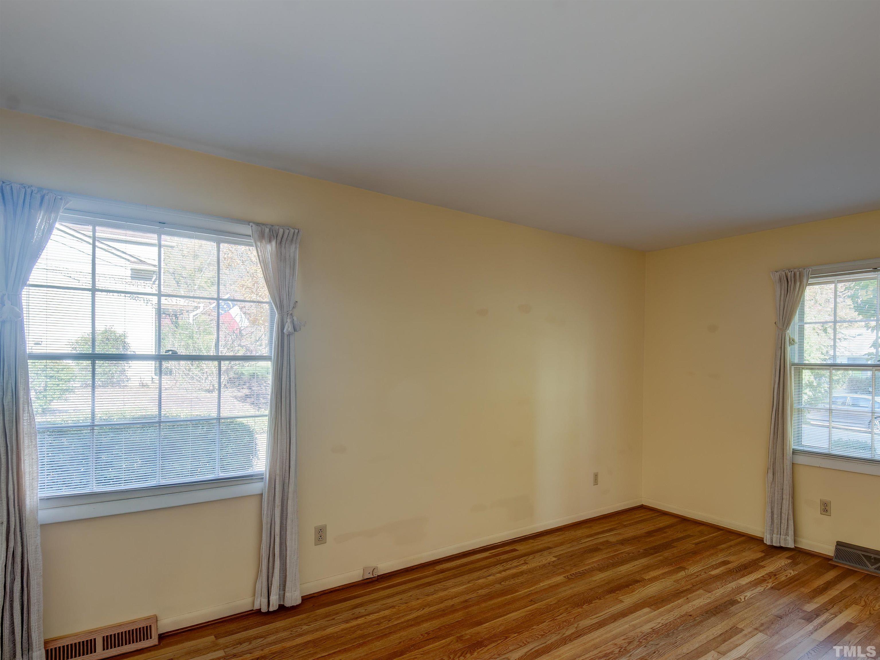 4821 Latimer Road Raleigh, NC 27609 - Photo 16 of 21 an empty room with wooden floor and windows
