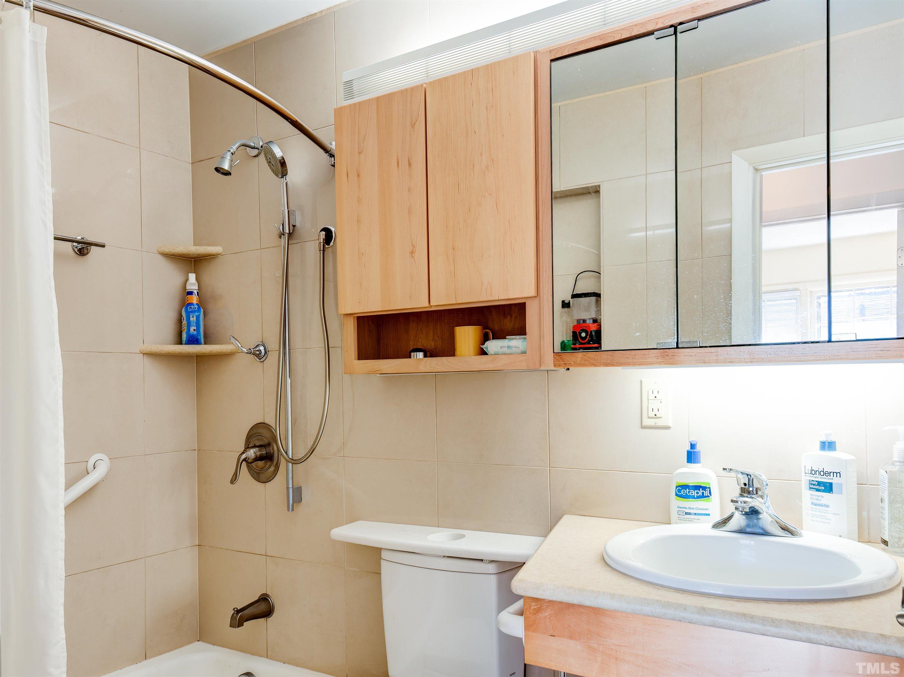 4821 Latimer Road Raleigh, NC 27609 - Photo 17 of 21 a bathroom with a sink a toilet and shower curtain