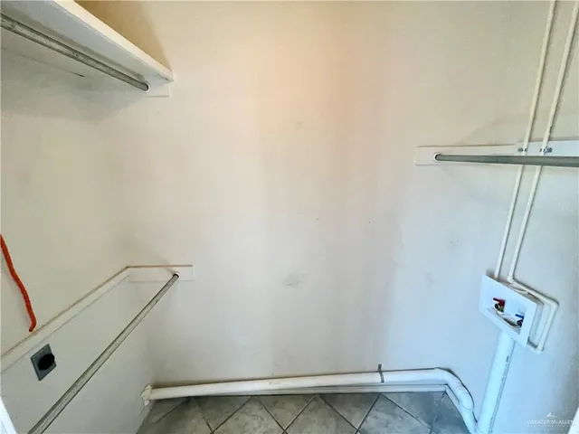 a view of storage and utility room with a fireplace