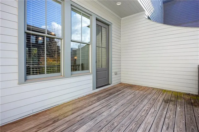 a view of house with deck and wooden floor