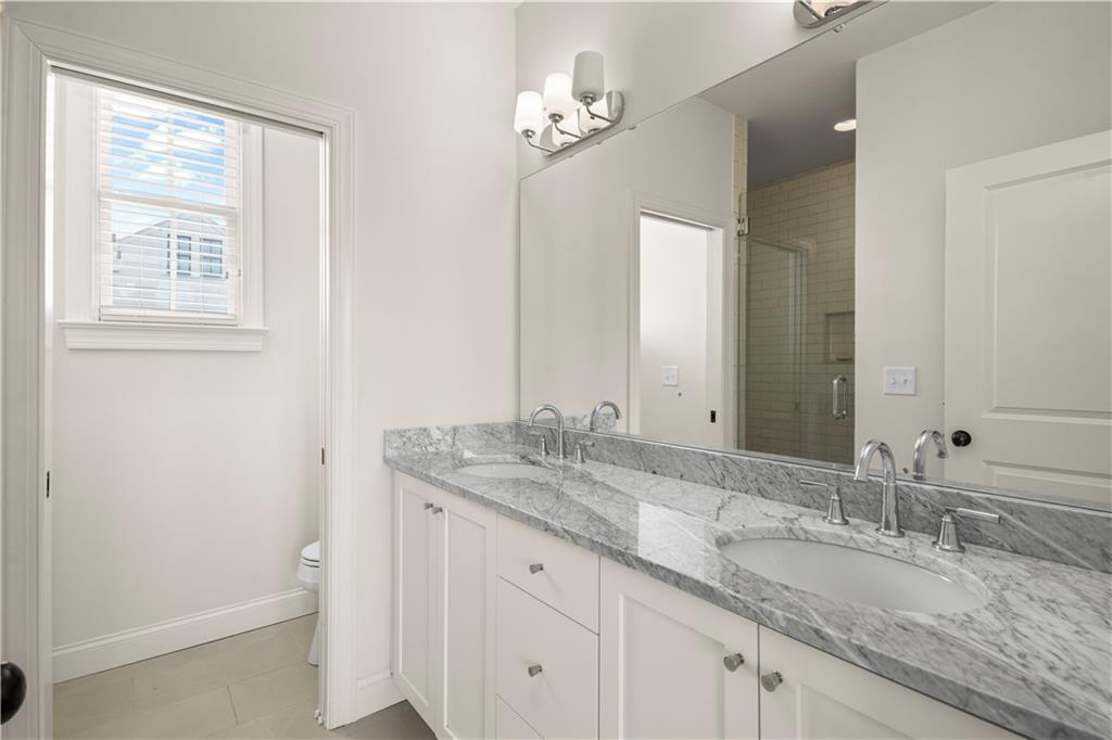689 Fraser Street Southeast Atlanta, GA 30315 - Photo 21 of 32 a bathroom with a granite countertop sink and a mirror