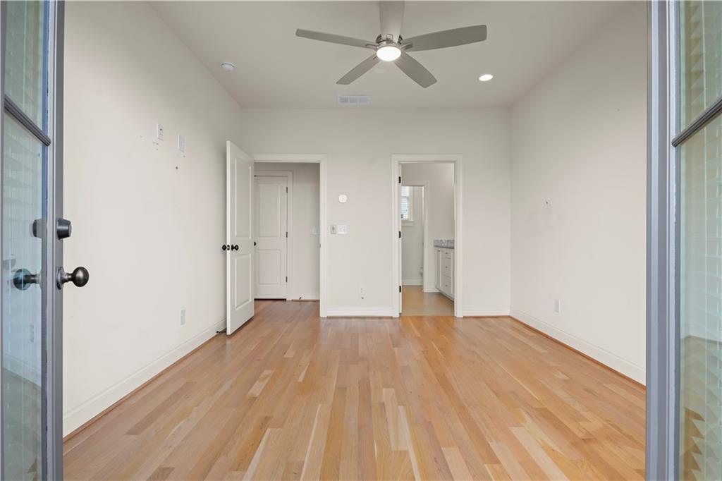 689 Fraser Street Southeast Atlanta, GA 30315 - Photo 25 of 32 a view of an empty room with wooden floor