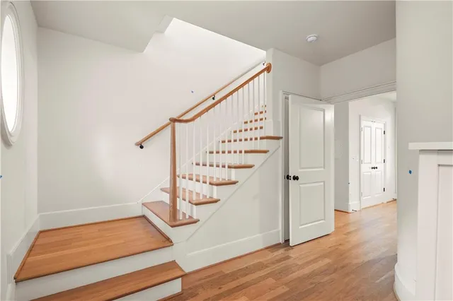 a view of entryway with wooden floor and stairs