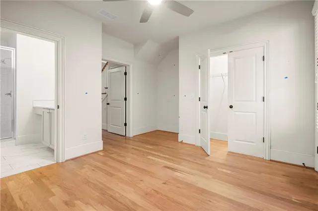 a view of empty room with wooden floor
