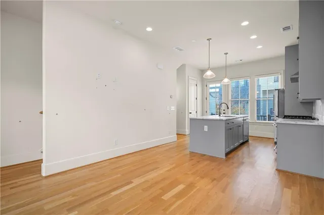 a large kitchen with a lot of counter top space and a sink