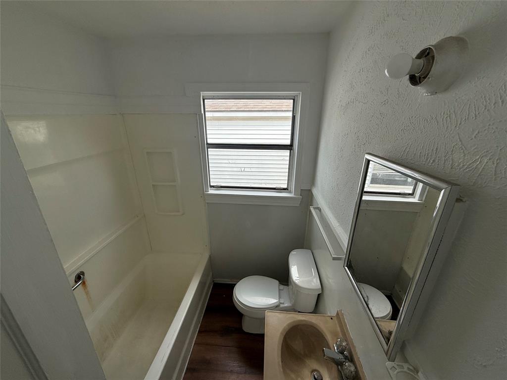 301 Boyd Loop Bonham, TX 75418 - Photo 11 of 11 a bathroom with a toilet and a sink