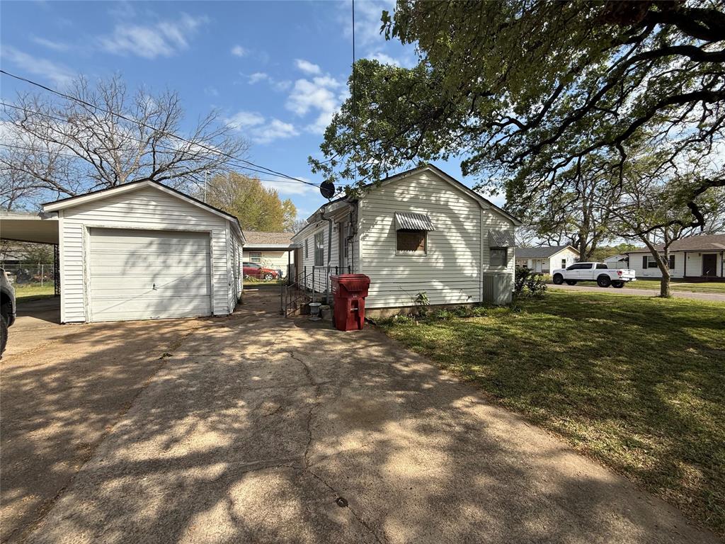 301 Boyd Loop Bonham, TX 75418 - Photo 2 of 11 a front view of a house with a yard and garage